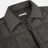 View 2 of product The Battersea Shadow Grey Quilted Jacket by Turnbull & Asser features a front zipper, buttoned cuffs, pointed collar, and multiple pockets—an ideal choice for the modern gentleman. Shown on a plain white background.