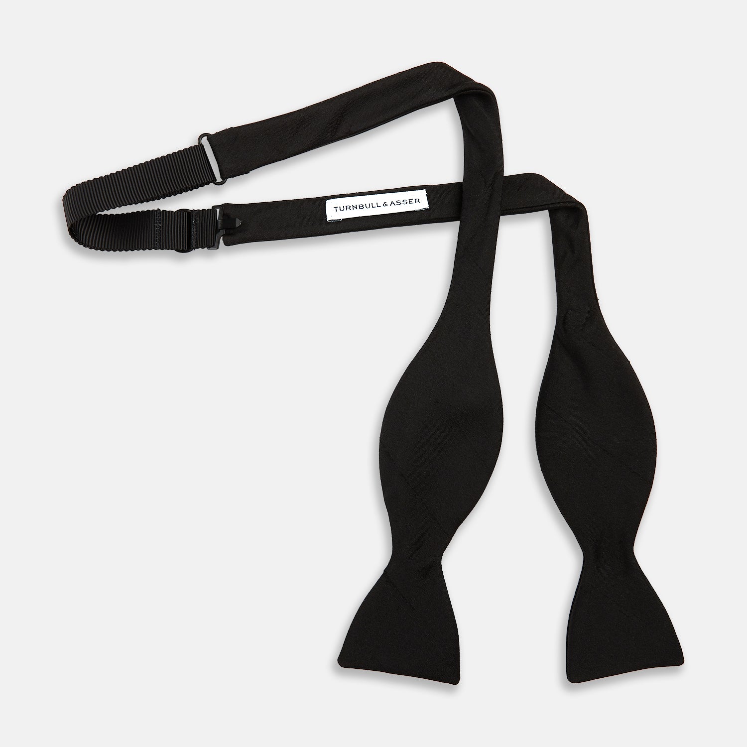 Image 3 of product The Casino Royale Bow Tie by Turnbull & Asser, as seen on James Bond, is a classic black Shantung silk bow tie with a smooth, slightly shiny finish, shown against a plain white background.