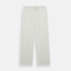 View 6 of product The Turnbull & Asser Cream Silk Pyjama Set, shown laid flat on a white background, features a long-sleeve button-up top with a chest pocket and matching pants with an elastic drawstring waist—ideal for comfortable loungewear.