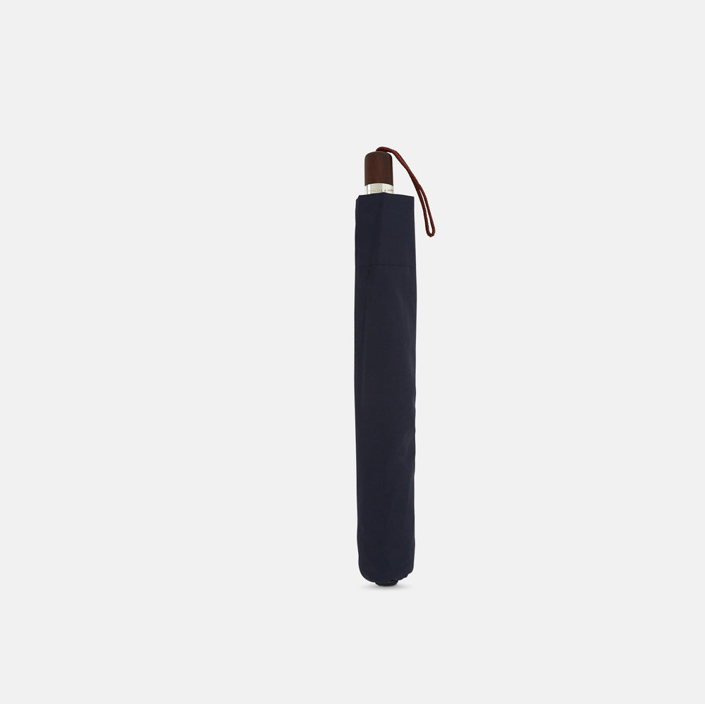 The Navy Telescopic Umbrella by Turnbull & Asser features a brown maple handle with wrist strap, a straight metal shaft, and is shown fully opened against a plain white background.