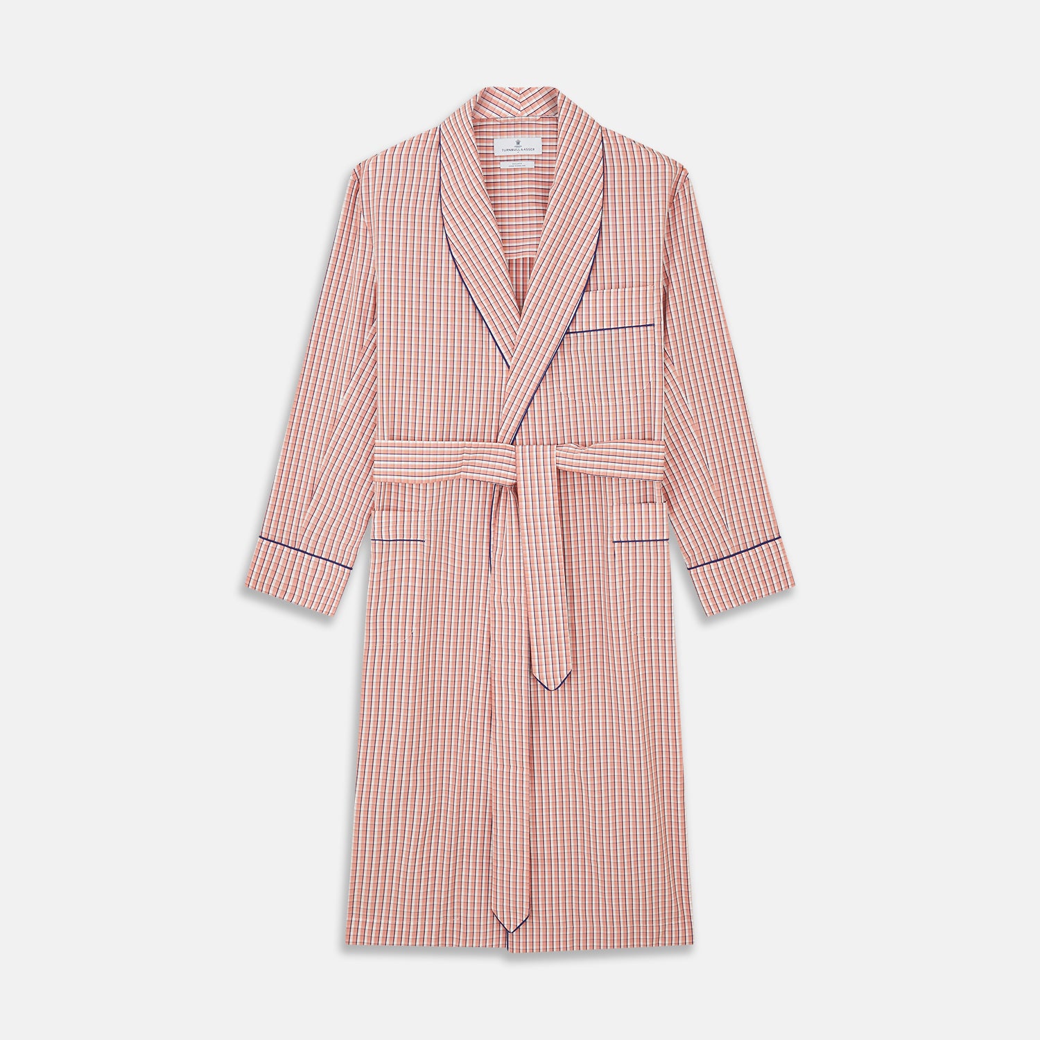 View 1 of product The Turnbull & Asser Orange Multi Check Cotton Arnold Gown features long sleeves, a shawl collar, wrap-around belt, and dark piping on the edges and pocket, displayed flat on a white background.