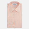 View 5 of product The Turnbull & Asser Orange Ticking Stripe Mayfair Shirt features thin vertical stripes, a classic T&A collar, and buttoned cuffs, shown on a plain white background.