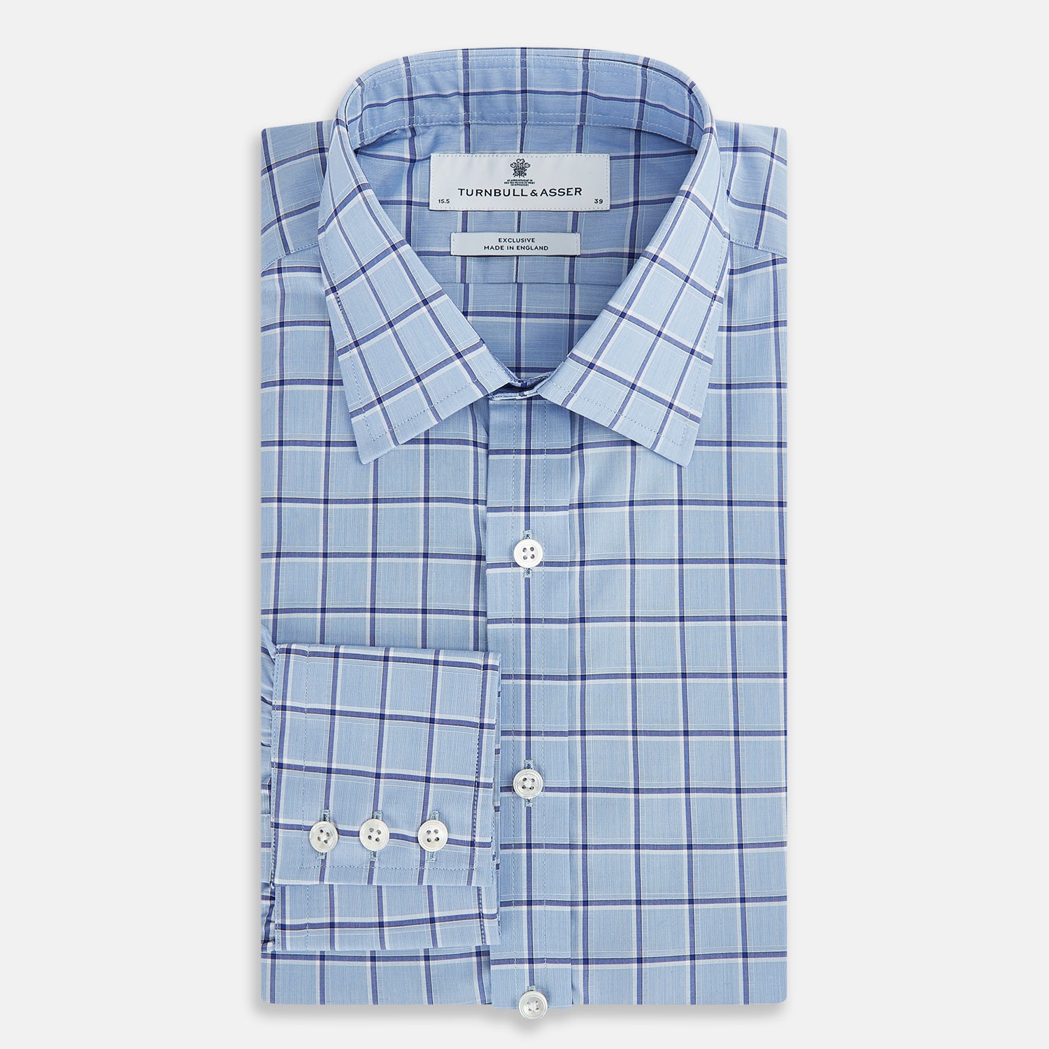 View 5 of product The Turnbull & Asser Blue and Navy Windowpane Mayfair Shirt features long sleeves, a T&A collar, buttoned cuffs, and Italian cotton in a blue and navy windowpane pattern, shown on a plain white background.