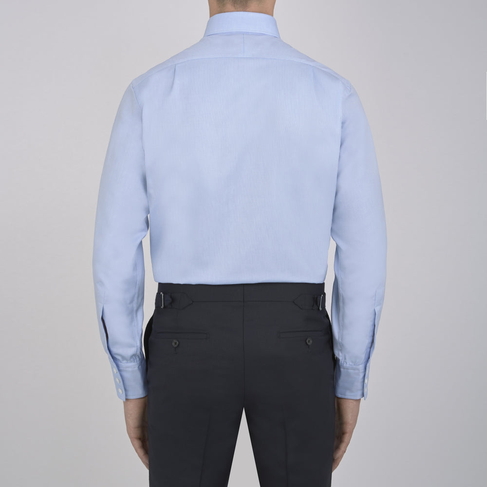 The Turnbull & Asser Light Blue Royal Oxford Cotton Shirt features a button-down collar, 3-button cuffs, and white buttons. Neatly folded with a visible inner label, it’s ideal to pair with a navy suit and displayed on a plain white background.