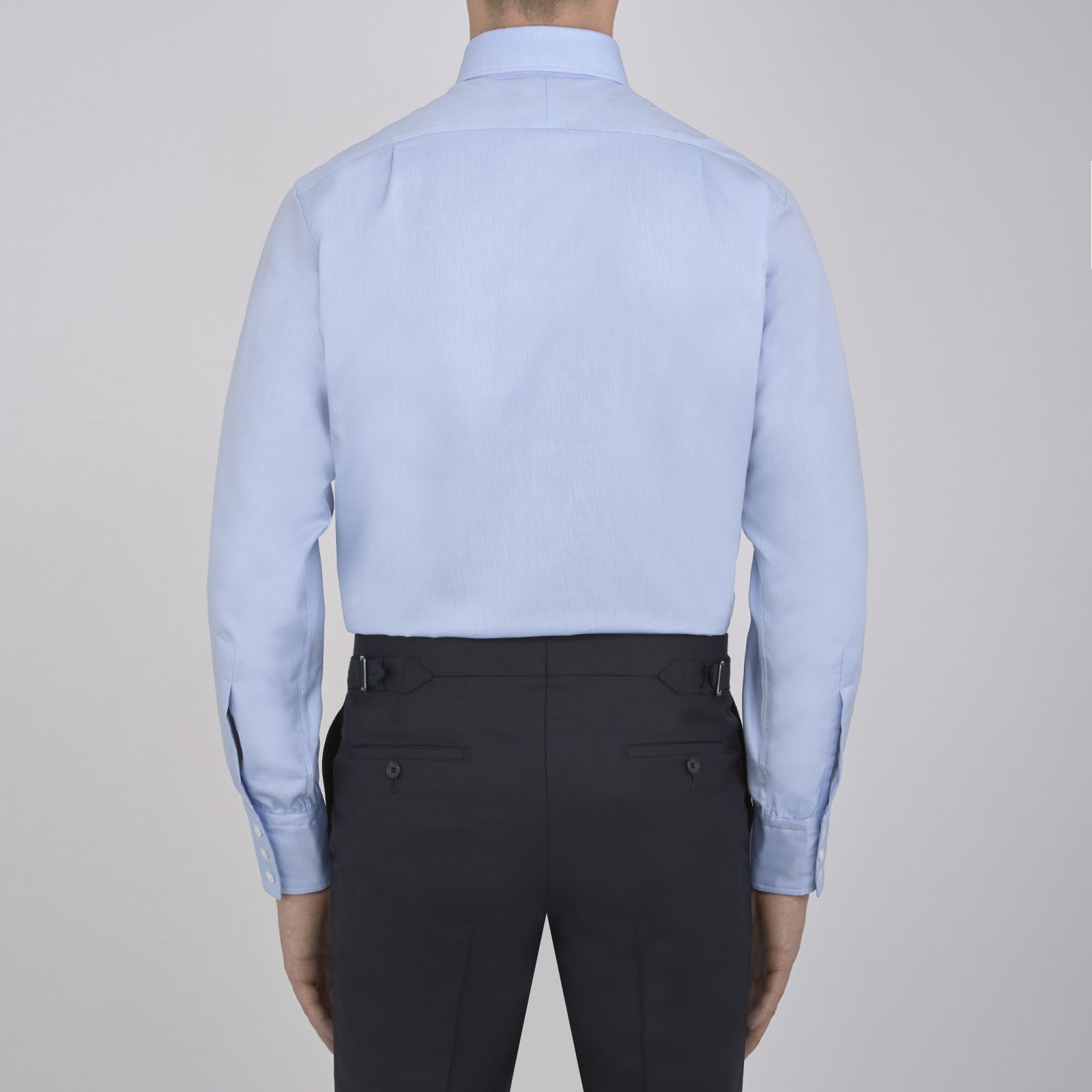 View 5 of product The Turnbull & Asser Light Blue Royal Oxford Cotton Shirt features a button-down collar, 3-button cuffs, and white buttons. Neatly folded with a visible inner label, it’s ideal to pair with a navy suit and displayed on a plain white background.