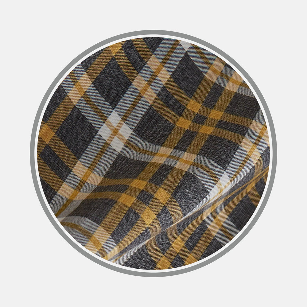 Close-up of BESPOKE FABRIC 1158 35 by Turnbull & Asser, showcasing a black, yellow, and white plaid pattern in a circular frame on light gray—perfect for crafting custom shirts or adding classic monogram flair.