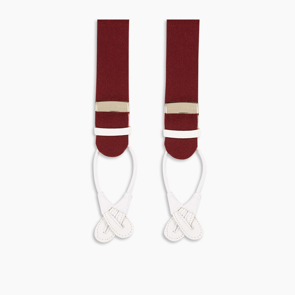 Image 3 of product A pair of Turnbull & Asser Bordeaux Adjustable Felt Braces, featuring white leather ends and gold metal adjusters, made in England, are displayed vertically on a plain white background.