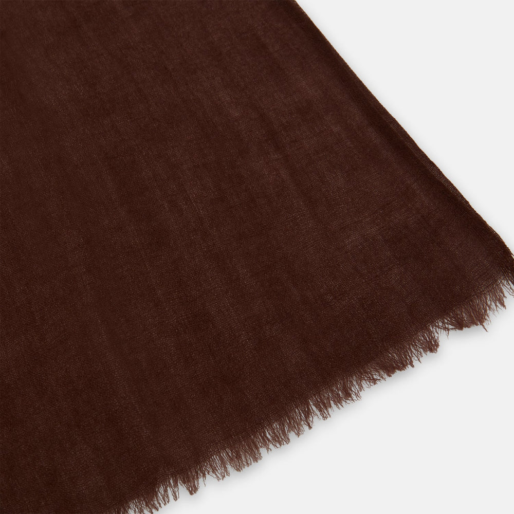 The Turnbull & Asser Dark Chocolate Cashmere Scarf is neatly folded with fringed edges and loose ends, showcasing its lightweight, luxurious fabric on a plain white background.