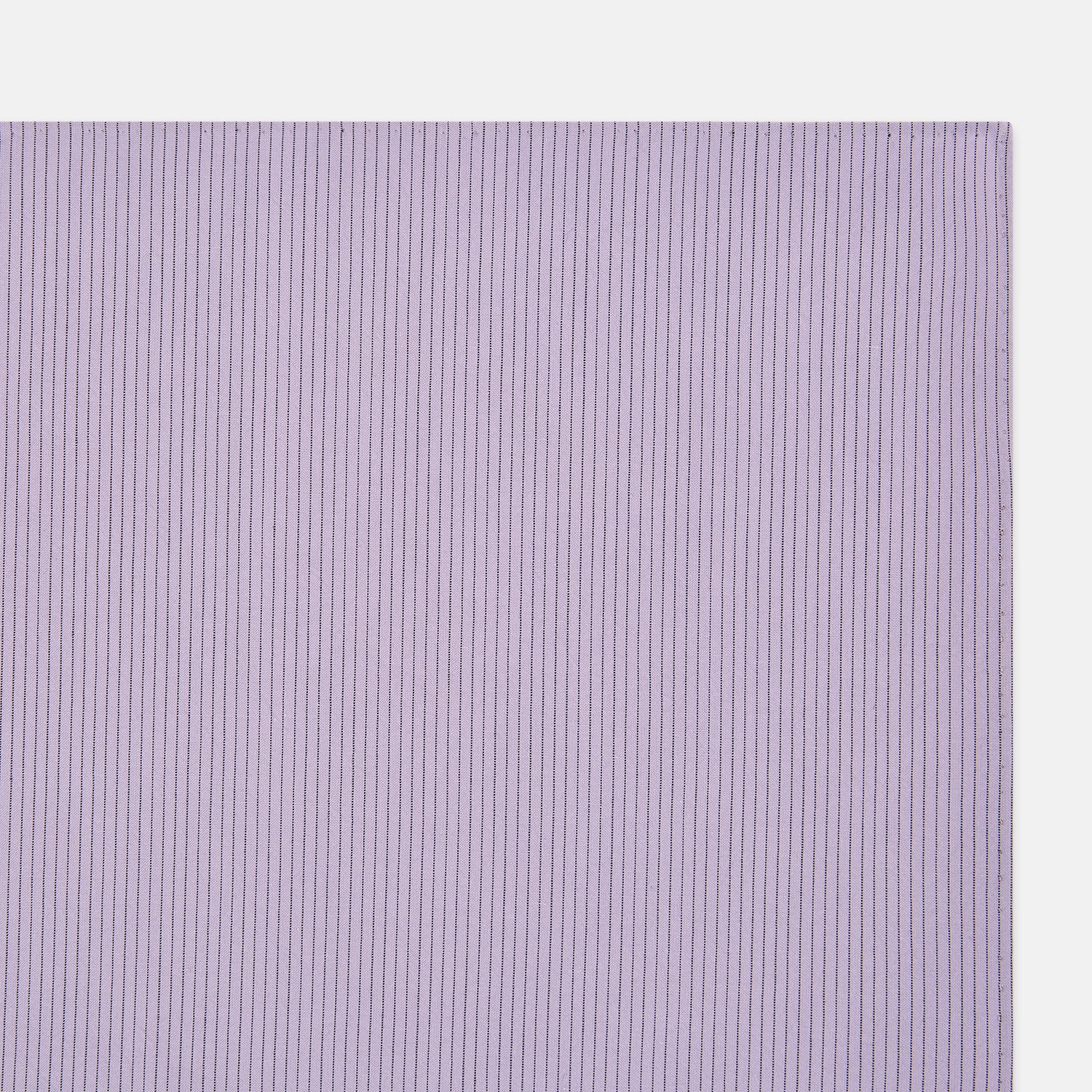 Image 2 of product The Turnbull & Asser Lilac Pinstripe Hand-Rolled Handkerchief is a neatly folded, square, lavender piece with a subtle ribbed texture and hand-rolled edges, displayed flat on a white background.