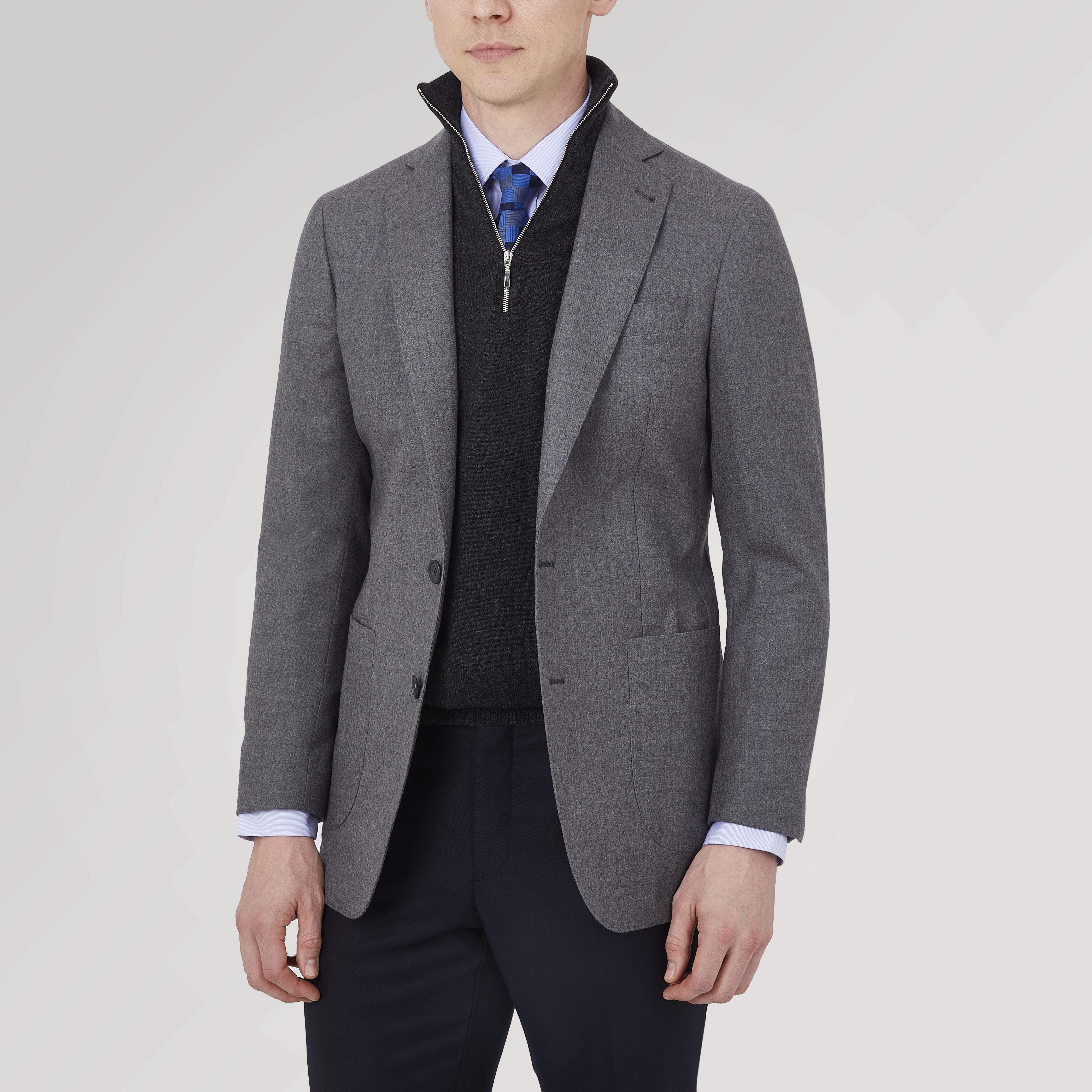 View 2 of product The Turnbull & Asser Grey Merino Wool Jacket is single-breasted with a notched lapel, two front patch pockets, and a single button closure, fashioned from fine Super Merino Wool. Shown here against a plain white background.