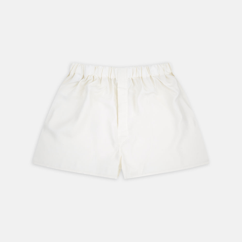 Turnbull & Asser Cream Silk Boxer Shorts feature an elastic waistband and a minimalist design, offering comfort and timeless style in premium silk, beautifully displayed flat on a light gray background.