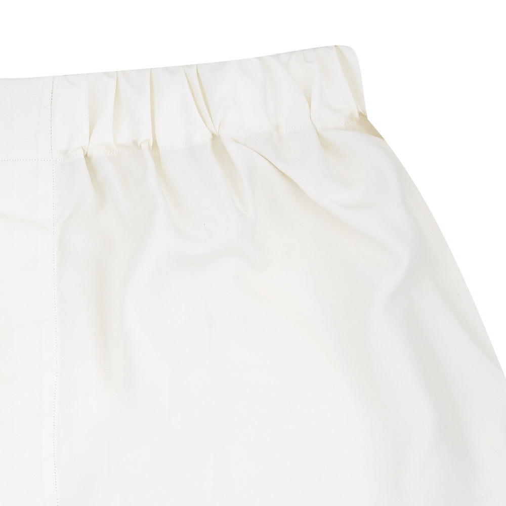 Turnbull & Asser Cream Silk Boxer Shorts feature an elastic waistband and a minimalist design, offering comfort and timeless style in premium silk, beautifully displayed flat on a light gray background.