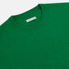 View 2 of product The Turnbull & Asser Grass Green Cashmere Round Neck Jumper features long sleeves, ribbed cuffs, collar, and hem, shown on a white background.