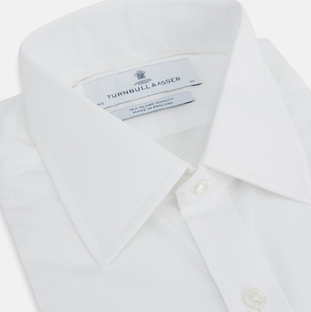 The Turnbull & Asser White Sea Island Quality Cotton Shirt features a T&A collar and 3-button cuffs, crafted from luxurious cotton and displayed on a white background.