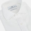 View 2 of product The Turnbull & Asser Tailored Fit White Marcella Front Shirt features a Kent Collar and double cuffs, shown laid flat on a white background. Perfect as a black tie shirt for formal events.