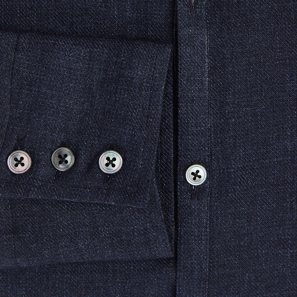 The Navy Linen Windsor Shirt by Turnbull & Asser features long sleeves, white buttons, a Turnbull collar, and buttoned cuffs in dark navy blue linen. Shown laid flat on a white background.