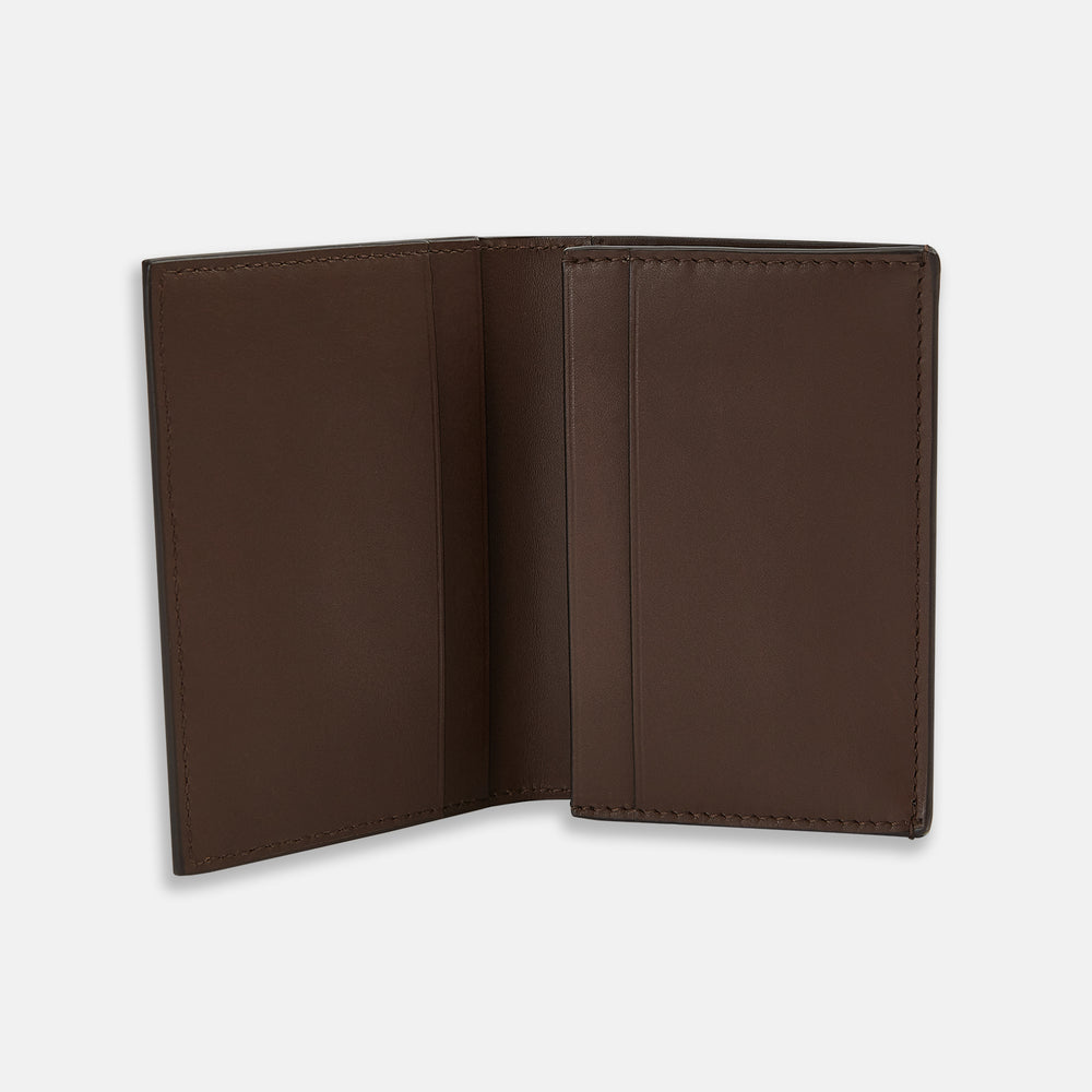 The Dark Brown Leather Bi-Fold Card Holder by Turnbull & Asser features neat edge stitching and the brand's name embossed in white on the front.