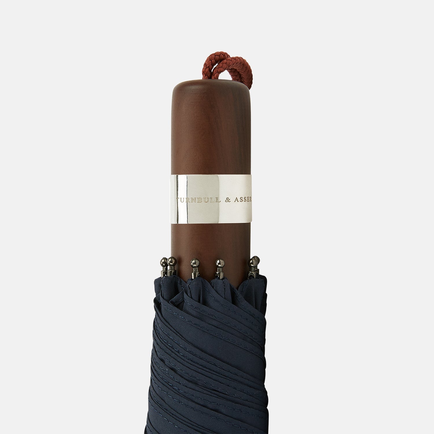 View 3 of product The Navy Telescopic Umbrella by Turnbull & Asser features a brown maple handle with wrist strap, a straight metal shaft, and is shown fully opened against a plain white background.