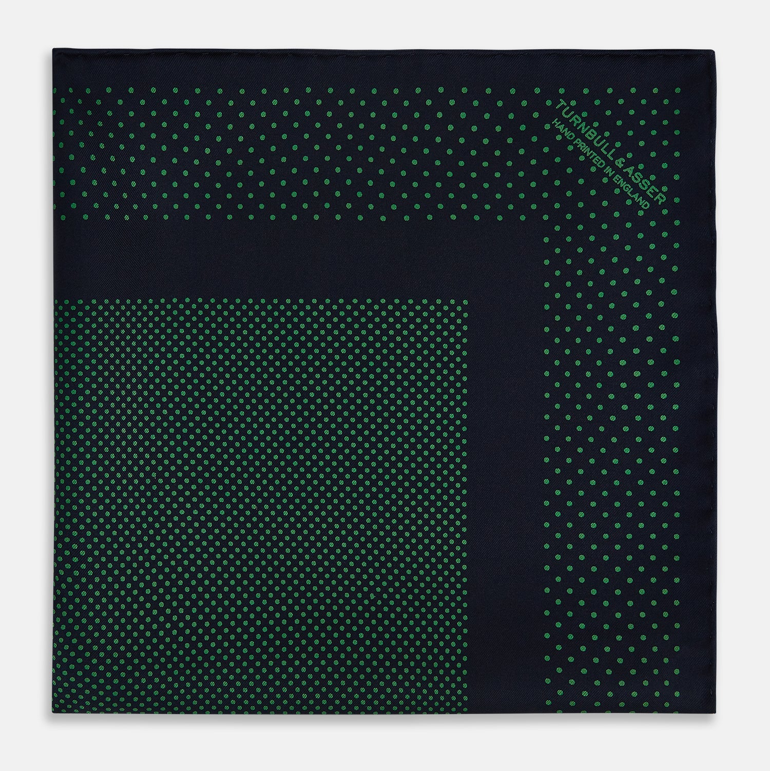 View 3 of product The Turnbull & Asser Navy and Green Dot Silk Pocket Square features dense green polka dots on navy silk, a solid navy border, and a band of spaced green dots—expertly handmade with precise finishing for an elegant look.