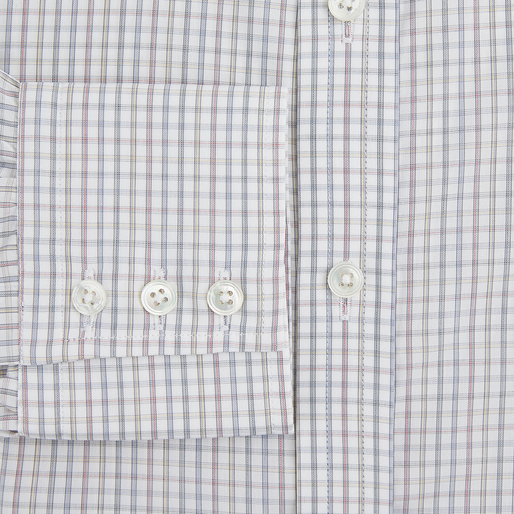 The Turnbull & Asser Sky Blue Multi Graph Check Shirt features long sleeves, a button-up front, pointed T&A collar, buttoned cuffs, and a small blue-and-white check pattern, shown on a white background.