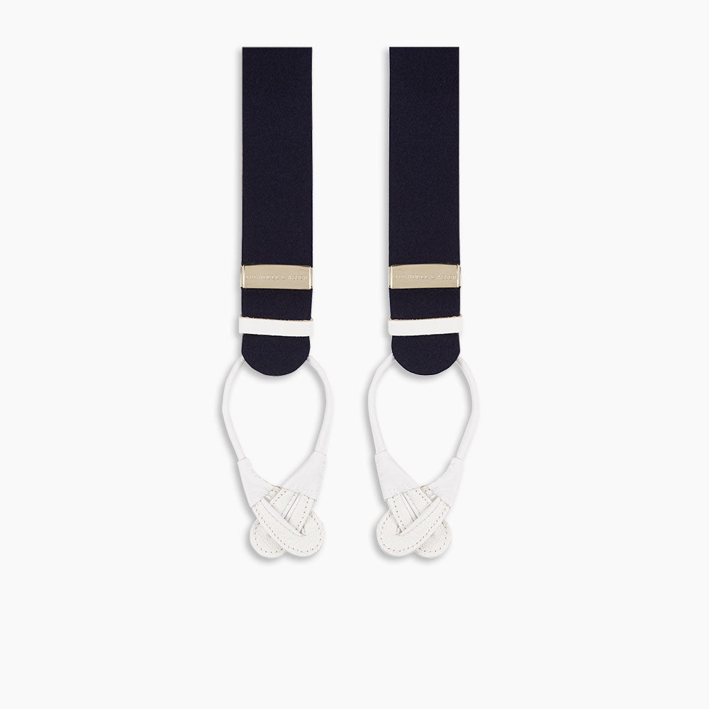 A pair of Turnbull & Asser Navy Adjustable Felt Braces, featuring pure wool boxcloth, white leather button loops, and gold-toned metal details, shown vertically on a plain white background. Expertly crafted in England for timeless style.