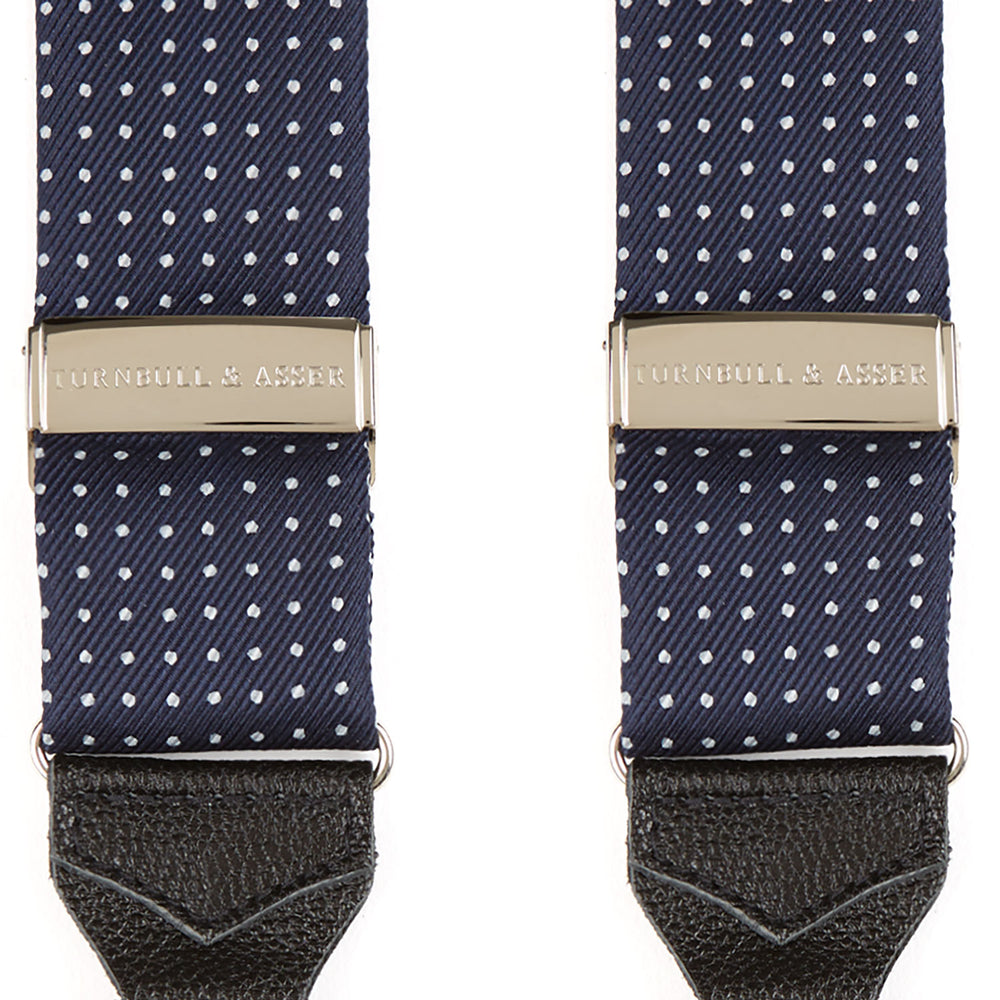 Turnbull & Asser Navy & White Small Spot Adjustable Silk Braces feature black leather loops and silver clasps—timeless accessories displayed on a white background.