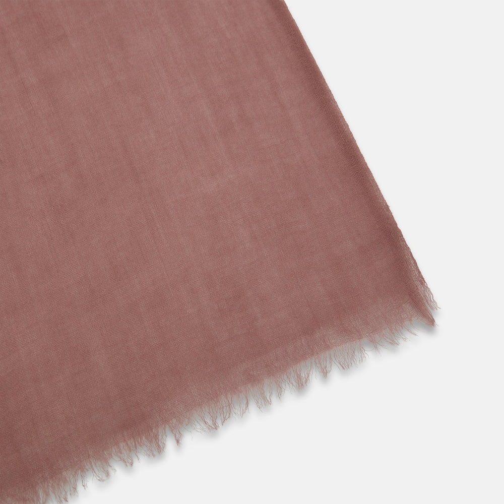 The Turnbull & Asser Pink Cashmere Scarf is a soft, lightweight luxury accessory with frayed edges, beautifully folded and displayed on a white background.