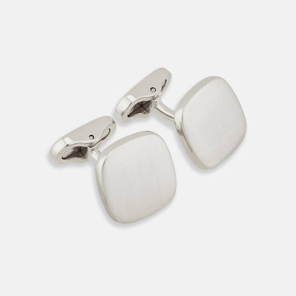 The Brushed Silver Rounded Square Cufflinks by Turnbull & Asser, shown on a plain white background, are a timeless addition to men's accessories.