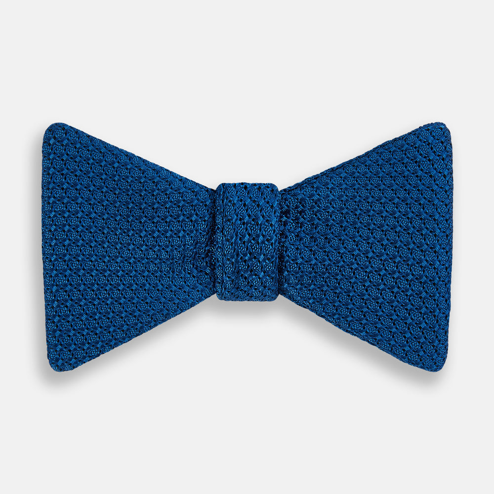 The Turnbull & Asser Azzurro Grenadine Silk Bow Tie, featuring a subtle circular pattern, is crafted from premium silk and shown on a plain white background—a refined accessory for elegant style.