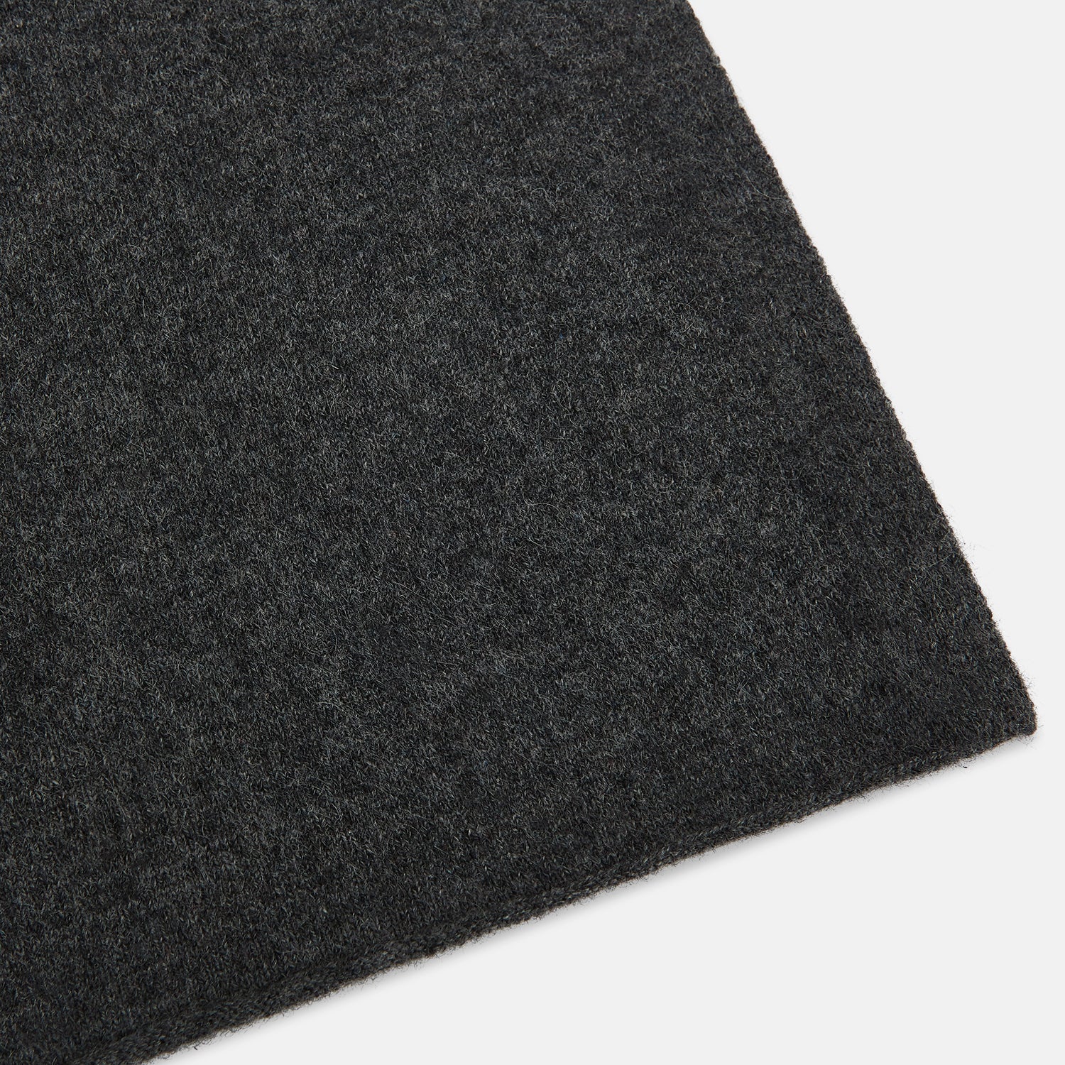 Image 2 of product The Turnbull & Asser Plain Graphite Cashmere Knitted Scarf, draped and loosely knotted on a white background, showcases the refined elegance and timeless style of a luxury accessory.