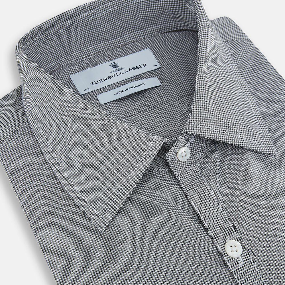 The Turnbull & Asser Grey and White Micro Check Westminster Shirt features long sleeves, a button-up front, a Westminster collar, and white buttons, shown flat on a white background.