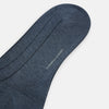 View 3 of product The Ash Dash Striped Long Sock by Turnbull & Asser—a single knee-high, dark blue over-the-calf sock with ribbed texture—is displayed on a plain, light background.