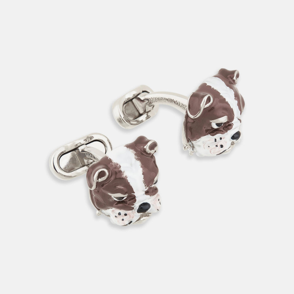 Turnbull & Asser’s British Bulldog Cufflinks, crafted in sterling silver and detailed with brown and white enamel to resemble bulldog heads, celebrate British heritage against a plain white background.