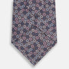 View 3 of product The Turnbull & Asser Purple and Blue Circle Ash Silk Tie is crafted from fine English silk and features a pattern of small blue, pink, and white circles on a dark ash background.