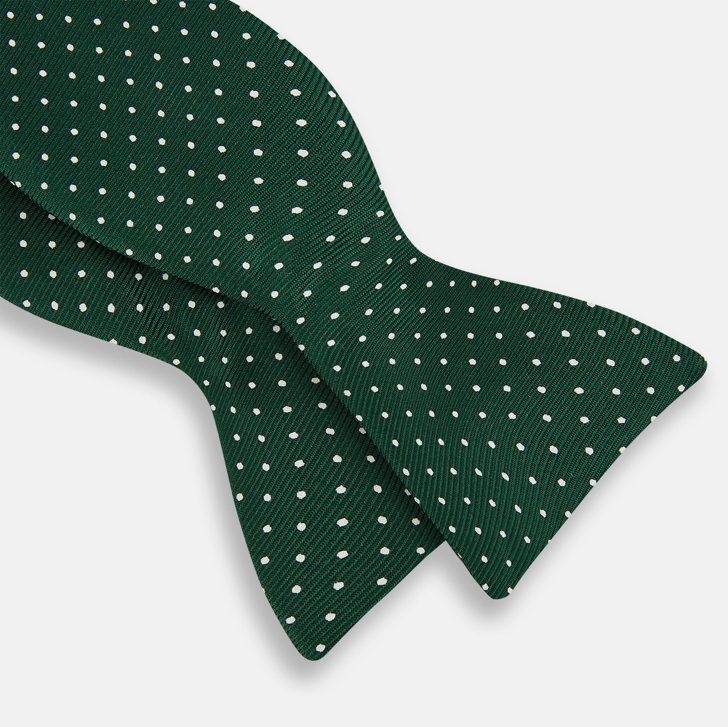 View 3 of product The Turnbull & Asser Racing Green and White Spot Silk Bow Tie features small white polka dots on luxurious silk, shown against a plain white background.