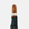 View 3 of product The Turnbull & Asser Colquhoun Tartan Telescopic Umbrella features a green, blue, and red plaid canopy, a durable metal shaft, and a brown maple crook handle, displayed against a plain light background.