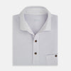 View 4 of product A soft pink cotton polo shirt by Turnbull & Asser features short sleeves, a contrasting white collar, three dark buttons, and a left chest pocket. Laid flat on a white background—it’s perfect for modern men’s fashion.