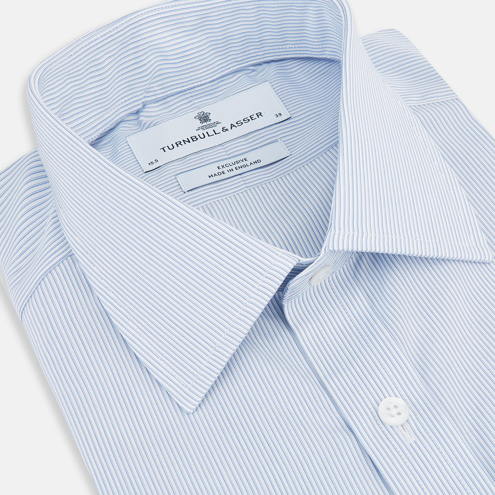 The Sky Blue Hairline Multi Stripe Mayfair Shirt by Turnbull & Asser, made from Italian cotton with a classic collar, white buttons, and buttoned cuffs, is displayed on a plain white background—an essential for any gentleman.
