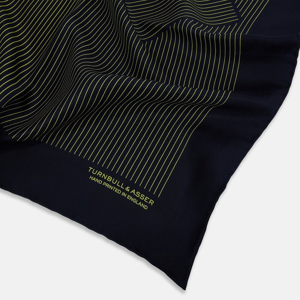 Turnbull & Asser Navy and Yellow Stripe Silk Pocket Square features hand-rolled edges, striped pattern, and "Turnbull & Asser Hand Printed in England" text in yellow on the bottom right corner.