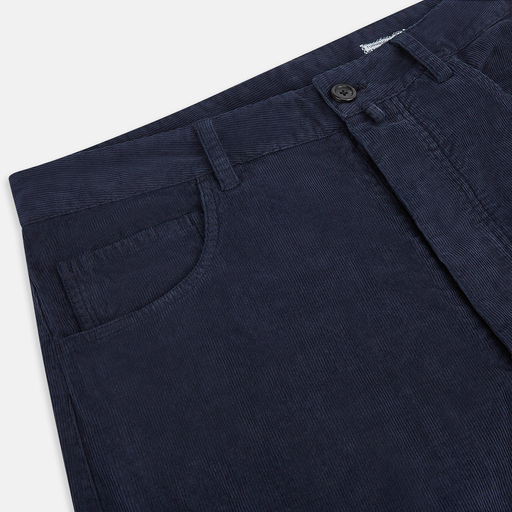 The Turnbull & Asser Light Navy Corduroy Charles Trousers feature a straight-leg fit, stretch cotton, belt loops, front pockets, and a button-zip closure—highlighting British tailoring against a white background.