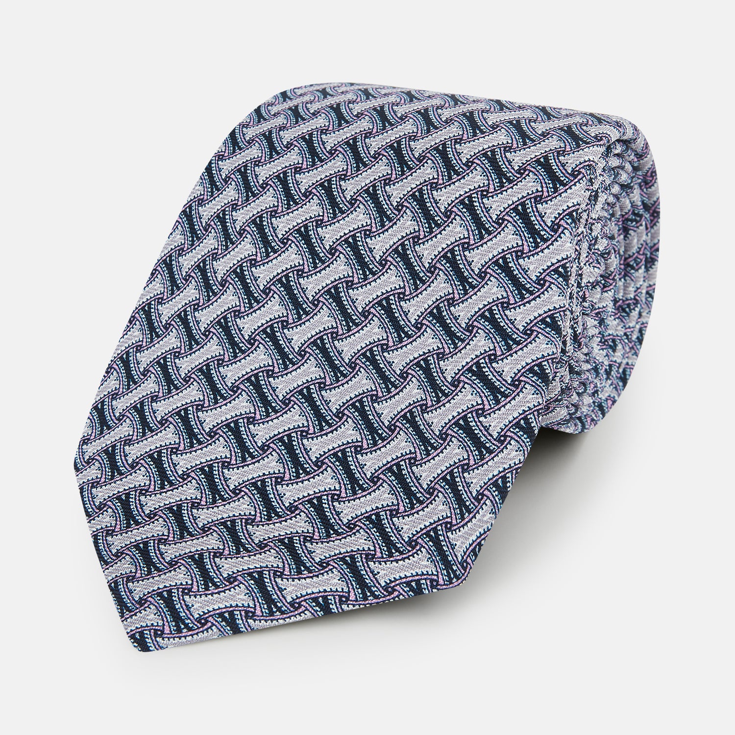 View 1 of product The Turnbull & Asser Navy and Pink Weave-Patterned Printed Silk Tie is shown rolled up on a white background, featuring a stylish geometric design.