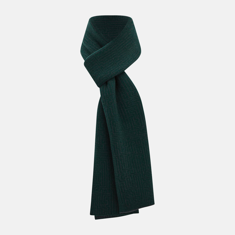 The Turnbull & Asser Forest Green and Charcoal Fretwork Cashmere Knitted Scarf, featuring a subtle geometric pattern, is neatly folded and knotted against a plain white background.