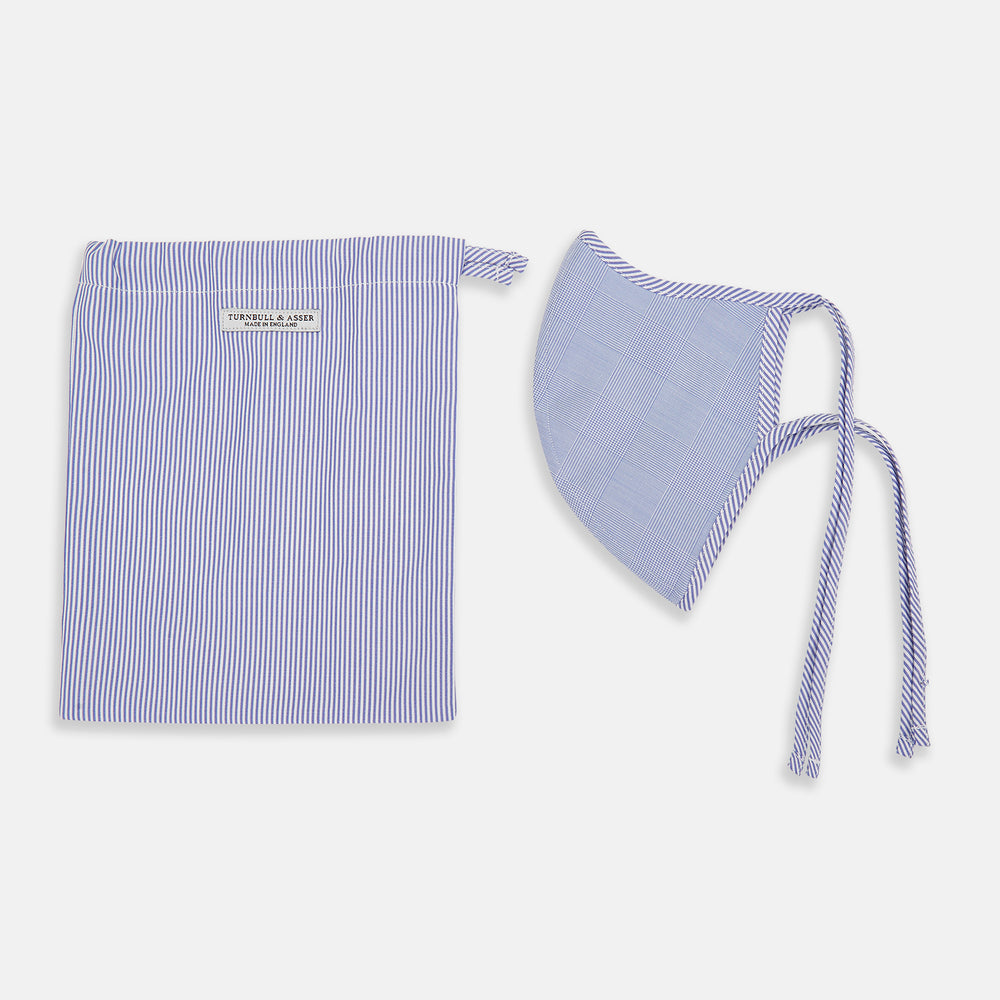 The Turnbull & Asser Blue Fine Check Zephyr Cotton Commuter Mask features a light blue and white check pattern, adjustable side ties, and comes with 3 Viroformula™ filters. Shown on a plain white background.