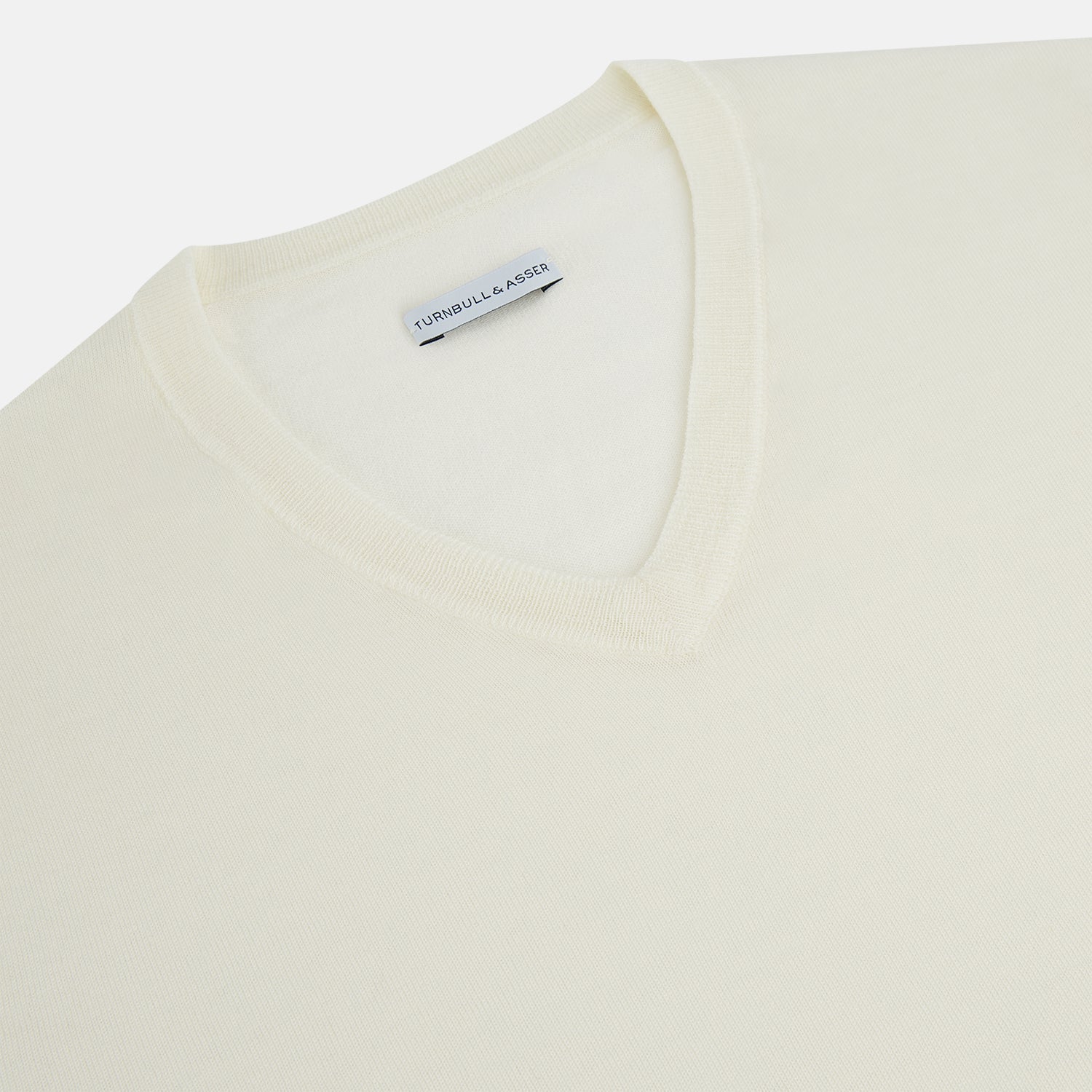 View 2 of product The Turnbull & Asser Cream Fine Merino V-Neck Jumper features long sleeves and classic styling, displayed against a white background.