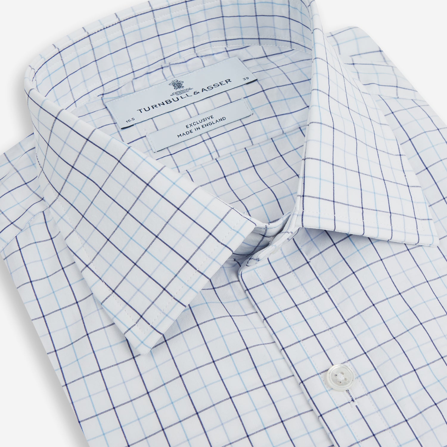 View 2 of product The Blue Overlay Grid Check Mayfair Shirt by Turnbull & Asser features a light blue and white grid check pattern with long sleeves and button-up design, making it a versatile wardrobe staple. Displayed on a plain white background.