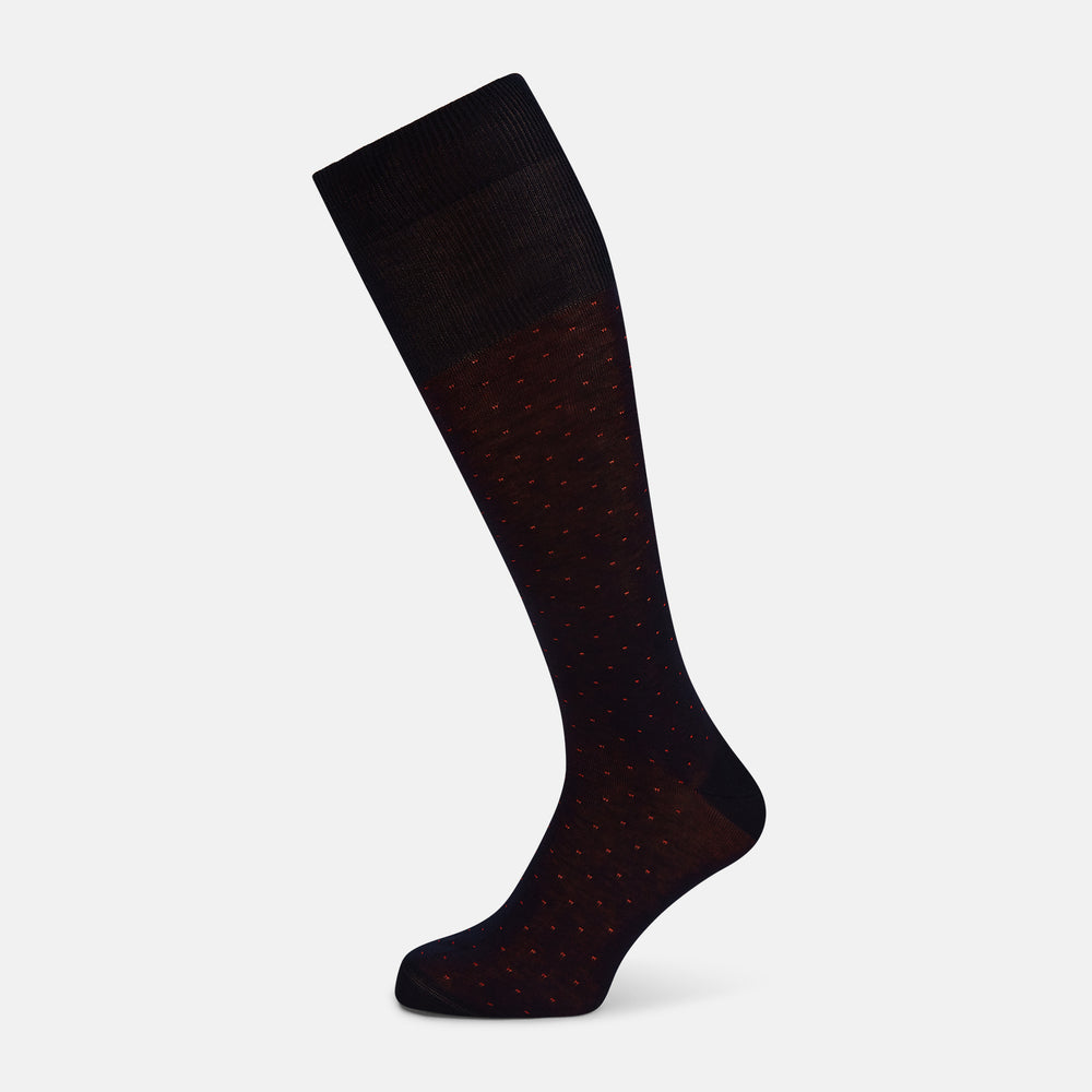 A single Turnbull & Asser Navy/Red Polka Dot Long Sock, crafted from mercerised Egyptian cotton, is displayed against a plain white background.