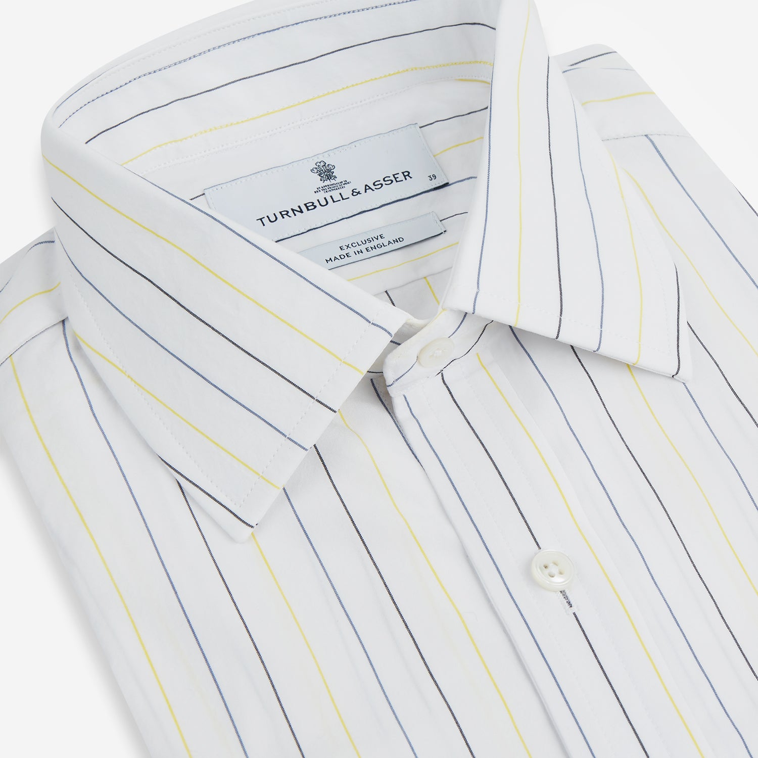 View 2 of product The Navy and Yellow Wide Pinstripe Mayfair Shirt by Turnbull & Asser is a long-sleeve, button-up shirt with wide navy and yellow pinstripes, a collar, and buttoned cuffs, laid flat on a white surface.