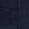 View 4 of product The Turnbull & Asser Mid Blue Highbury Overshirt features long sleeves, a button-up front, collar, and single chest pocket, shown laid flat on a white background.