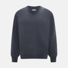 View 1 of product The Turnbull & Asser Grey Cashmere Round Neck Jumper is shown against a light gray background, featuring a relaxed fit with ribbed cuffs, collar, and hem for an elegant look.