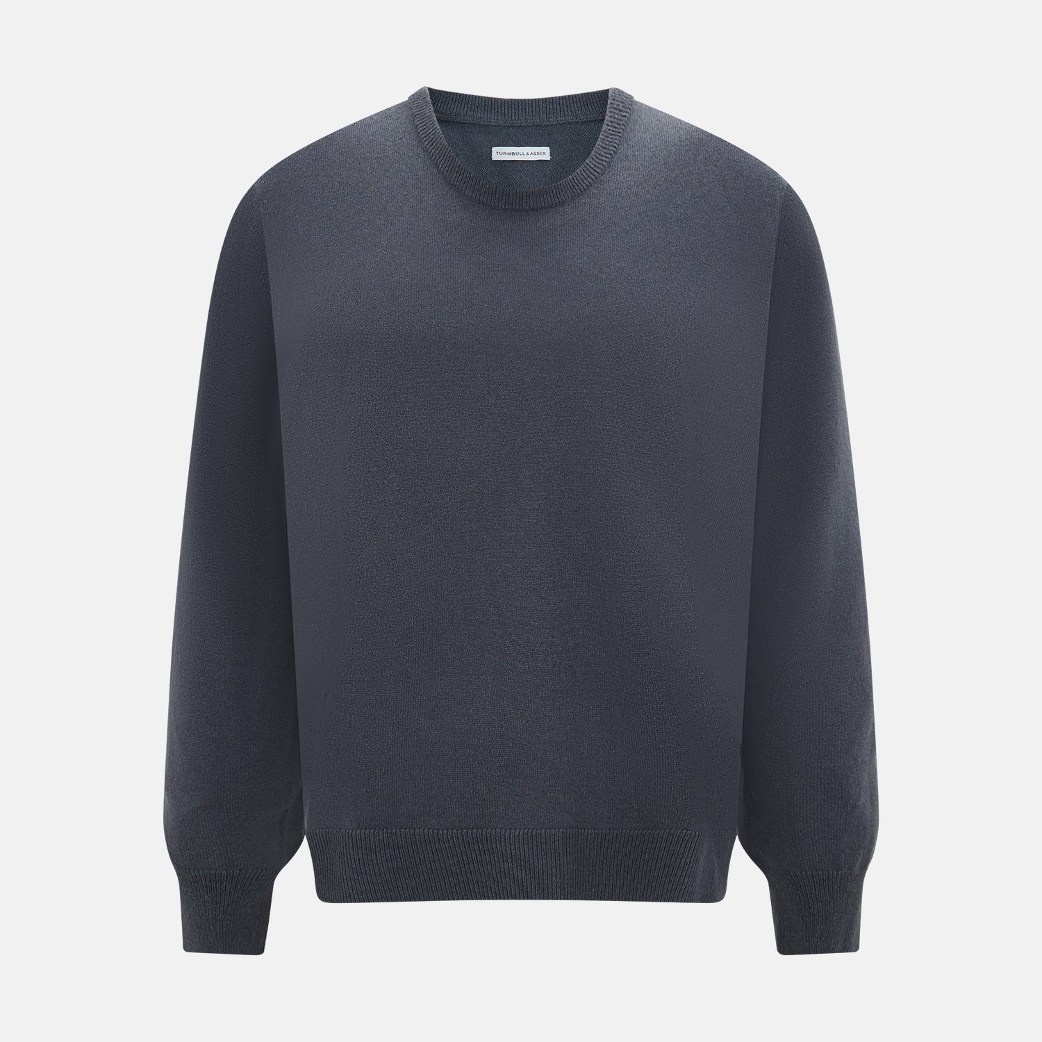 View 1 of product The Turnbull & Asser Grey Cashmere Round Neck Jumper is shown against a light gray background, featuring a relaxed fit with ribbed cuffs, collar, and hem for an elegant look.